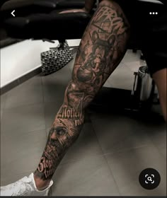 a man's leg with tattoos on it