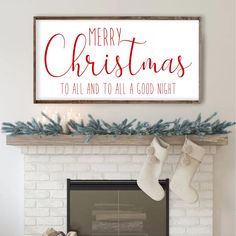 a fireplace with stockings and stockings hanging from it's mantle, next to a sign that says merry christmas