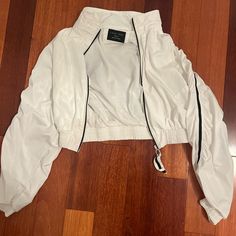 Never Worn White Nylon Track Jacket For Winter, White Spring Track Jacket With Zipper, White Track Jacket With Zipper For Spring, White Nylon Track Jacket With Pockets, White Track Jacket With Zipper Closure For Fall, White Track Jacket For Spring, White Urban Nylon Outerwear, White Nylon Urban Outerwear, White Urban Nylon Track Jacket