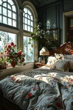 a bed sitting next to a window with flowers on it in front of two windows