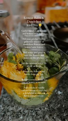 a glass bowl filled with yellow flowers on top of a counter next to other dishes