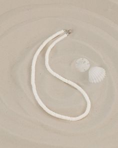 "This choker necklace features quality white shell heishi beads.  The literal meaning of heishi (pronounced hee-shee) is \"shell\" and these beads are made using pieces of oyster shell (also known as mother-of-pearl) made into flat beads. A string of good heishi will have a uniform consistency in bead size and if you gently pull it through your hand, it should feel like a single serpent-like piece.  When you look closely at each bead, you see the amazing detail and unique coloration of each bead Beach Jewelry With White Letter Beads, White Letter Beads Jewelry For Beach, White Beach Jewelry With Letter Beads, White Heishi Beads Necklace For Beach, White Jewelry With Letter Beads For Vacation, White Heishi Beads Strand Necklace, White Heishi Beads Single Strand Necklace, White Single Strand Heishi Beads Necklace, White Heishi Beads Jewelry For Vacation