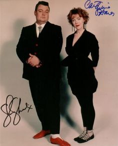 an autographed photo of two people standing next to each other