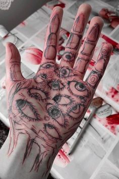 a person's hand with tattoos on it