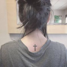 a woman with a cross tattoo on her neck