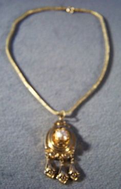 I am offering you this fabulous Victorian-style vintage yellow gold tone wide unique design lavaliere style necklace. It is a bold wonderful design that has such movement and flexibility to it , and such a gorgeous ornate design. Just look at the endless amounts of scrolled etched designs here, accented with jet black enameling. It is also accented with a faux pearl. Creating this dangle lavaliere section of this necklace, creating a wonderful shape giving this amazing necklace such added intere Gold Victorian Necklace For Evening, Victorian Gold Necklace For Evening, Victorian Gold Choker Necklace, Elegant Gold Chain Necklace With Vintage Charm, Gold Jewelry With Vintage Charm For Evening, Ornate Design, Etched Designs, Pretty Necklaces, Favorite Rings