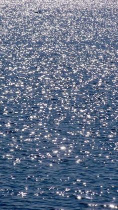 the sun shines on the water as it reflects off the ocean surface in this photo