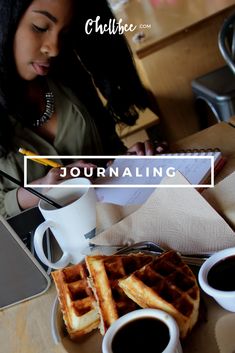 a woman sitting at a table with waffles and coffee