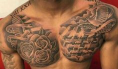 a man's chest with tattoos on it and some words written in the middle