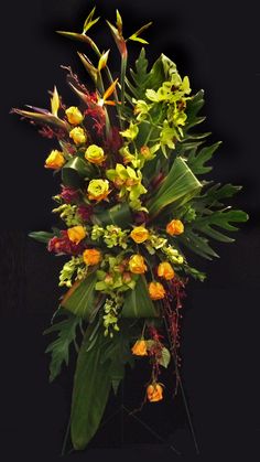 an arrangement of flowers and greenery on a black background with space for the text