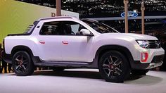 a white pick up truck on display at an auto show