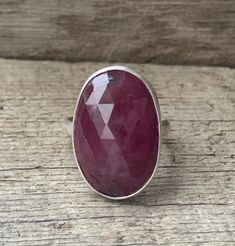 A stunning large oval deep red faceted raw sapphire has been set in sterling silver with a handmade ring band from sterling silver half dome wire. This stone is 23mm x 15mm in size and is a deep red with smaller darker accents throughout the stone. The faceted cut on the surface of the raw sapphire helps it catch the light and sparkle. There is 1 sister stone that can be made into a ring of any size! Stock Ring Size 8.25-8.75 ONLY. Made to order ring can be any size! Sapphires are the birthstone Sapphire Ring Engagement, Engagement Ring Raw, Raw Sapphire, Raw Stone Ring, September Birthstone Jewelry, Jewelry Elegant, Mauve Pink, September Birthstone, Elegant Ring