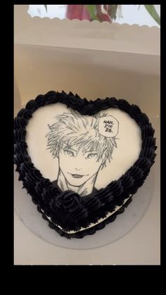 a heart shaped cake with an anime character drawn on it