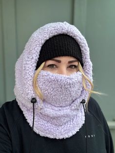 Balaclava - Sherpa FITS OVER HELMET! Fits over most adult helmets as well as over beanies  Hood made with Sherpa fleece Stay warm in style!  Wear with hood up or down, and face mask up or down  Pull strings with cord stops to stay tight  Adult size, fits most!  Beanie hat not included  100% polyester   Dry clean only!  *Pattern placement may vary Hooded Fleece-lined Balaclava For Winter, Winter Sports Balaclava With Adjustable Hood, Windproof Hats For Outdoor Winter Wear, Winter Beanie For Outdoor Activities With Fleece Lining, Windproof Winter Hats For Outdoor, Warm Balaclava For Winter Outdoor Activities, Winter Wear Windproof Hats For Outdoor, Winter Full Face Balaclava For Skiing, Full Face Balaclava For Skiing In Winter