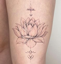 a woman's thigh with a flower tattoo on it