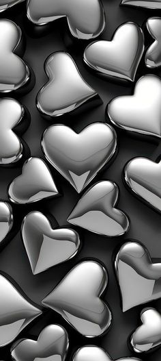 many shiny hearts are arranged in the shape of heart shapes on a black background with white highlights