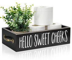 two rolls of toilet paper in a black box with the words hello sweet cheeks on it