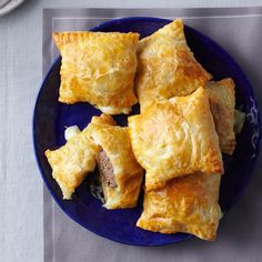 a blue plate topped with pastries on top of a table