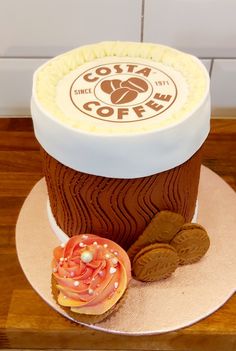 there is a coffee cake with cookies on the plate and frosting in the shape of a cupcake