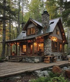 a small log cabin in the woods surrounded by rocks and trees, with lights on