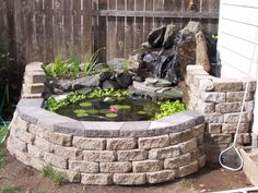 a small pond in the middle of a garden