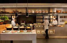 a man standing in front of a kitchen filled with lots of food on top of counter tops