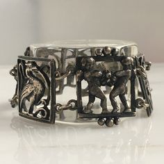 Details: Lovely 1940's Italian theme sterling bracelet. Images of Angels and birds (possibly phenix) grace this sweet bracelet. Would make a lovely gift! The bracelet is stamped Sterling on the inside of the clasp. Please ask all necessary questions prior to placing an order. Measurements: The bracelet measures 6 1/2 inches. The width of the bracelet is 3/4 inch. Condition: The overall all condition of this bracelet is very good. Antique Sterling Silver Bracelets, Vintage Sterling Silver Hallmarked Bracelet For Gift, Antique Silver Bracelet Gift, Vintage Hallmarked Sterling Silver Bracelet Gift, Vintage Bangle Bracelet With Sterling Silver Clasp, Antique Stamped 925 Bracelets For Gifts, Vintage Silver Bangle Charm Bracelet, Vintage 925 Stamped Bracelet Gift, Antique Silver Bracelets With Box Clasp