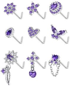 six pairs of purple jeweled jewelry on hooks, each with a cross and heart