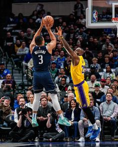 two basketball players in action on the court