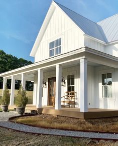 a white house with porch and covered patio