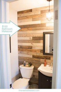 a bathroom with wood planks on the wall and a white toilet in front of it