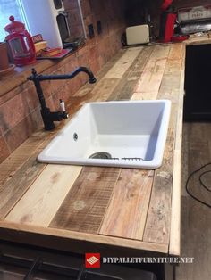 a white sink sitting on top of a wooden counter