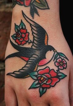 a hand with a bird and flowers on it