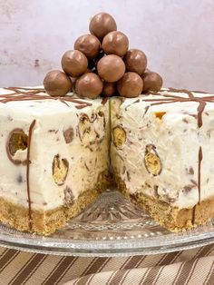 a cake with chocolate and white frosting on a glass plate next to a slice cut out