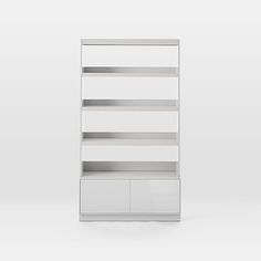 a white book shelf with two doors and drawers on the bottom, in front of a gray background