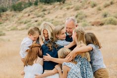 a group of people hugging each other in a field