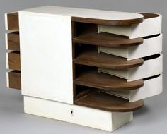 a white and brown cabinet with drawers on the front, two shelves at the bottom