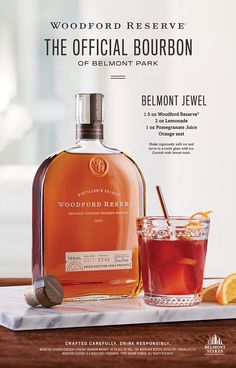 a bottle of woodford reserve bourbon next to a glass with an orange slice on it