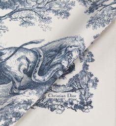 Modern yet timeless, The Toile de Jouy Sauvage blanket highlights the hallmark House motif. Crafted in white and navy blue wool, the style is embellished with hand-sewn edging and is further enhanced by the Christian Dior signature. The blanket can be draped over the shoulders or elegantly placed over living room furniture.. Denim Swimsuit, Blanket Poncho, Icon Shoes, Plaid Poncho, Christian Dior Couture, Winter Print, White Blanket, Dior Couture, Fashion Jewelry Earrings