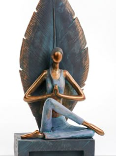 a statue of a woman sitting in a lotus position