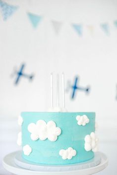 a blue cake with white clouds and crosses on it