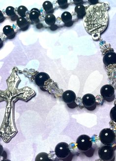 Beaded black obsidian rosary with swarvoski pearls as decade beads and Italian crucifix and connector. Supervise around small children as beads are a choking hazard. Black Beaded Cross-shaped Rosary, Black Beaded Cross Rosary, Handmade Black Cross Rosary Bracelet, Black Crucifix Rosary Bracelet As Gift, Black Crucifix Rosary As Gift, Beaded Rosary, Black Obsidian, Rosary, Charms