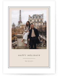 a man and woman posing for a photo in front of the eiffel tower