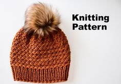 an orange knitted hat with a brown pom - pom