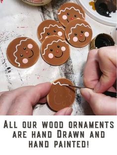 someone is making gingerbread cookies with the words, all our wood ornaments are hand drawn and painted