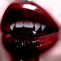 a woman's mouth with white teeth and red lipstick