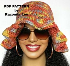 a mannequin head wearing a crocheted hat with large round sunglasses on it