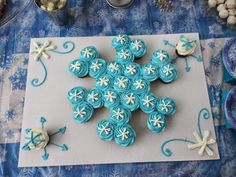 there are cupcakes that have been made to look like snowflakes on the table