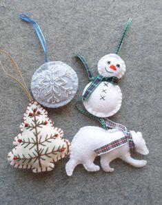 three ornaments are sitting on the floor next to each other and one has a snowman ornament