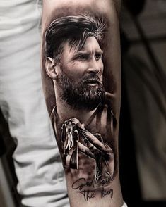 a man's arm with a black and grey portrait tattoo on it